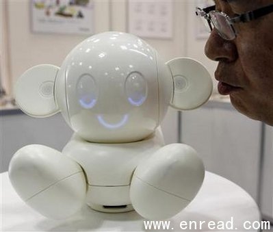 A man talks to Raytron\s communication robot \Chapit\ at a demonstration during ROBOTECH, an exhibition on service robot manufacturing technologies,in Tokyo, July 28, 2010.